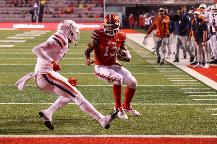 Utah Utes quarterback Nate Johnson (13) runs the ball for a touchdown against Arizona Wildcats cornerback Ephesians Prysock (7) in the second quarter at Rice-Eccles Stadium.